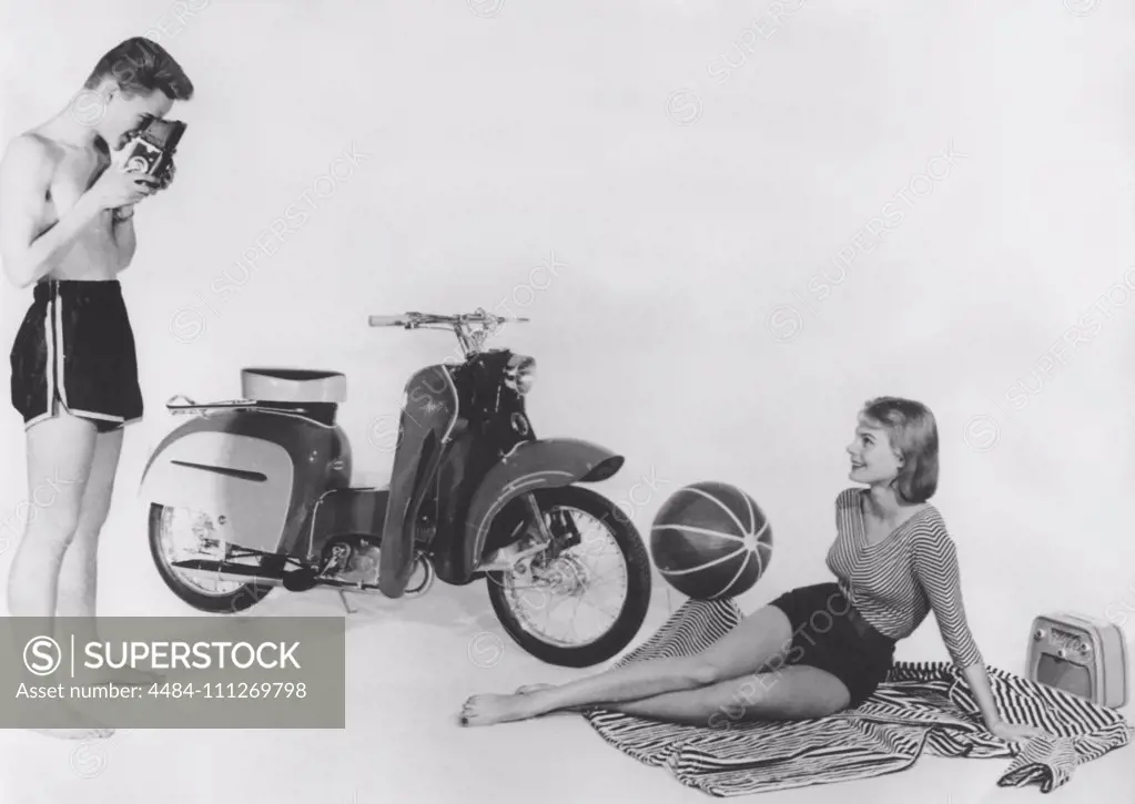 Teenagers of the 1950s. A teenage boy and girl with a brand new Monark Monarsccot model M33. A moped launched 1957 with a futuristic design with the looks of a vespa. It had two gears and costed 945 sek. Sweden 1957