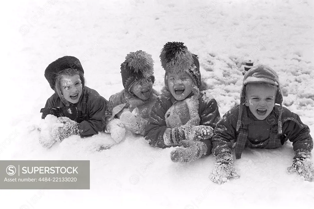 Winter in the 1950s. Children are playing in a park in Stockholm. They don't seem to be freezing. Sweden 1954. Ref 2A-14