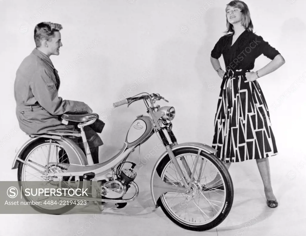 Teenagers of the 1950s. A teenage boy and girl with a brand new Monark moped. Sweden 1950s.