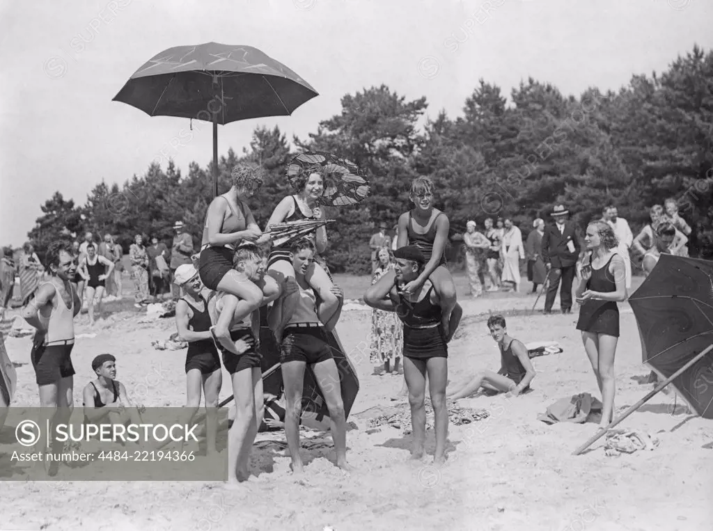 1920s beach party. A group of teenagers play on the beach outside Visby, a town on the Gotland island. 