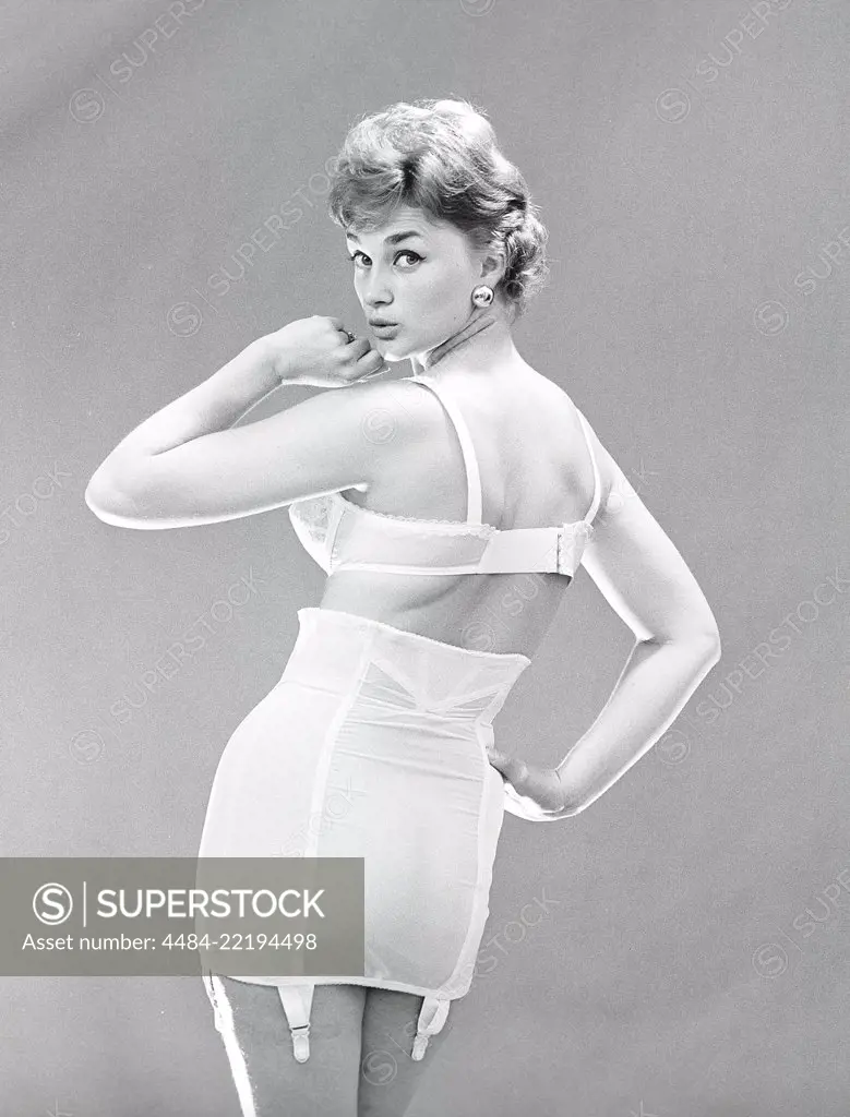 Woman of the 1950s. A woman is posing in typical 1950s underwear and bra.  Sweden 1950s. Photo Kristoffersson ref CU68-5. - SuperStock