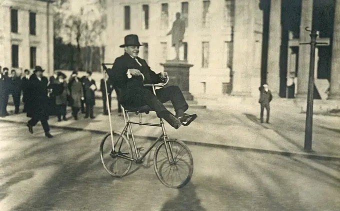 1920s man on a bicycle. The Swedish bicycle acrobat Fritiof Malmsten is performing his tricks on his special bicycle on Karl Johans square in Oslo. The bicycle model was called the swing bicycle and was an unusual invention with an extraordinary construction to perform balance acts and other tricks.