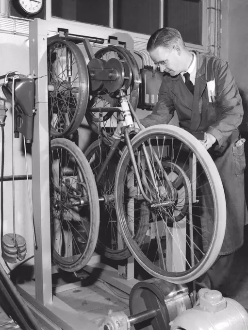 Factory in the 1950s. A worker at bicycle and motorcycle company Monark in Sweden.The bicycles are being tested and on this machine called the Shaker, the bicycle runs a 1000 km test run. Sweden 1958