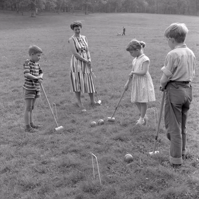 Summer activitiy in the 1950s. A mother and her children are playing croquet. Sweden 1957 Ref 3480