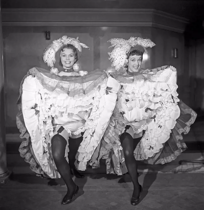 The Can-Can dance. A high-energy, physically demanding dance that became a popular music hall dance in the 1840s, continuing in popularity in French cabaret to this day. The main features of the dance are the vigorous manipulation of skirts and petticoats, along with high kicks, splits and cartwheels. Here two women posing in a typical Can-Can dresses in the 1950s. Photo Kristoffersson ref BS27-3 Sweden