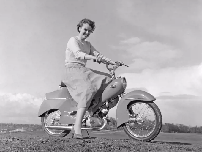 Woman of the 1950s. A young woman with a new Crescent moped 1956.