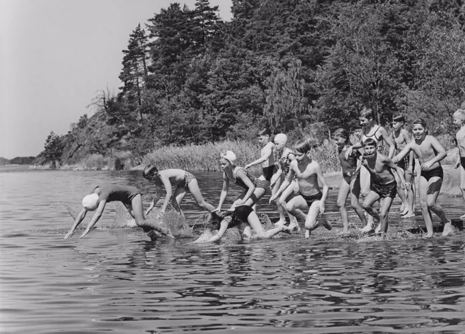 1960s summer. It's a sunny summer day and the children are running into the water. Sweden 1963
