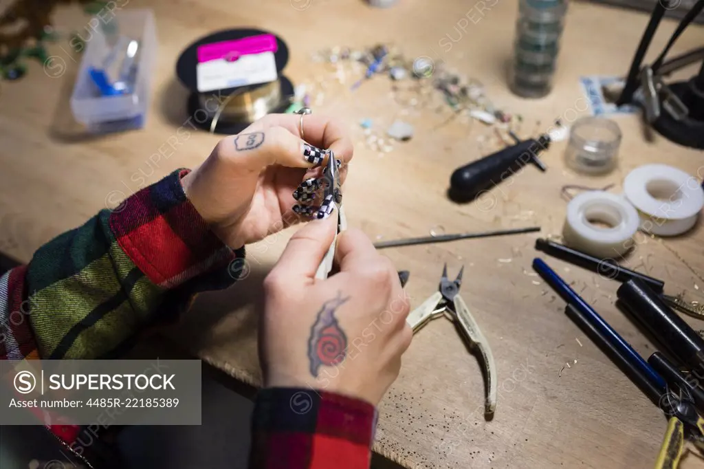 A young women who creates and sells jewlery out of her home