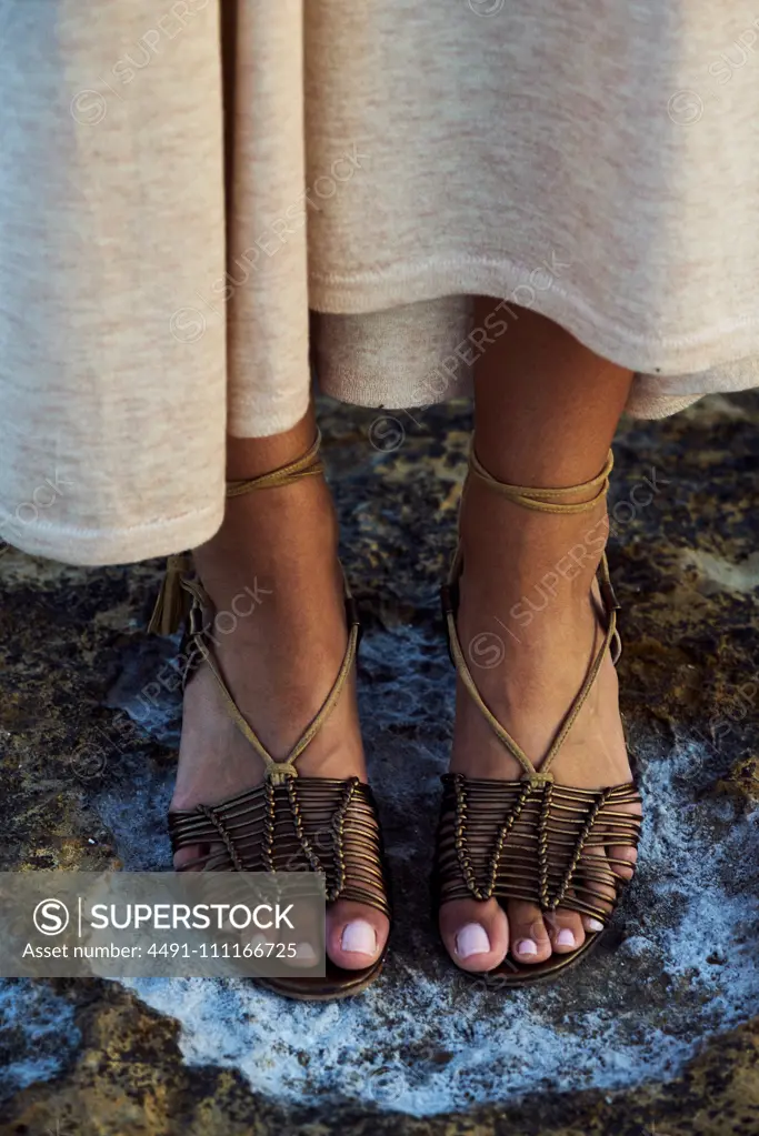 Closeup of stylish summer shoes on young woman feet