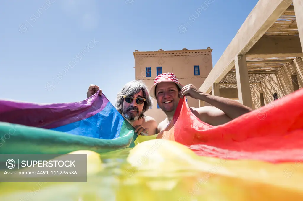 Happy gay couple in swimming pool