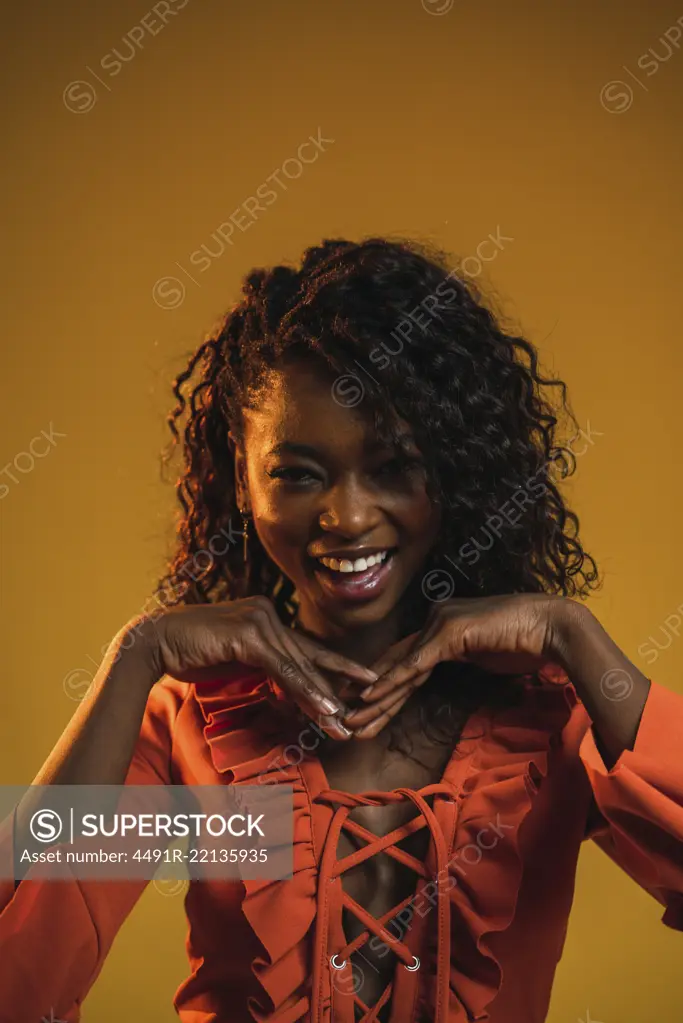 Cheerful black woman posing in studio