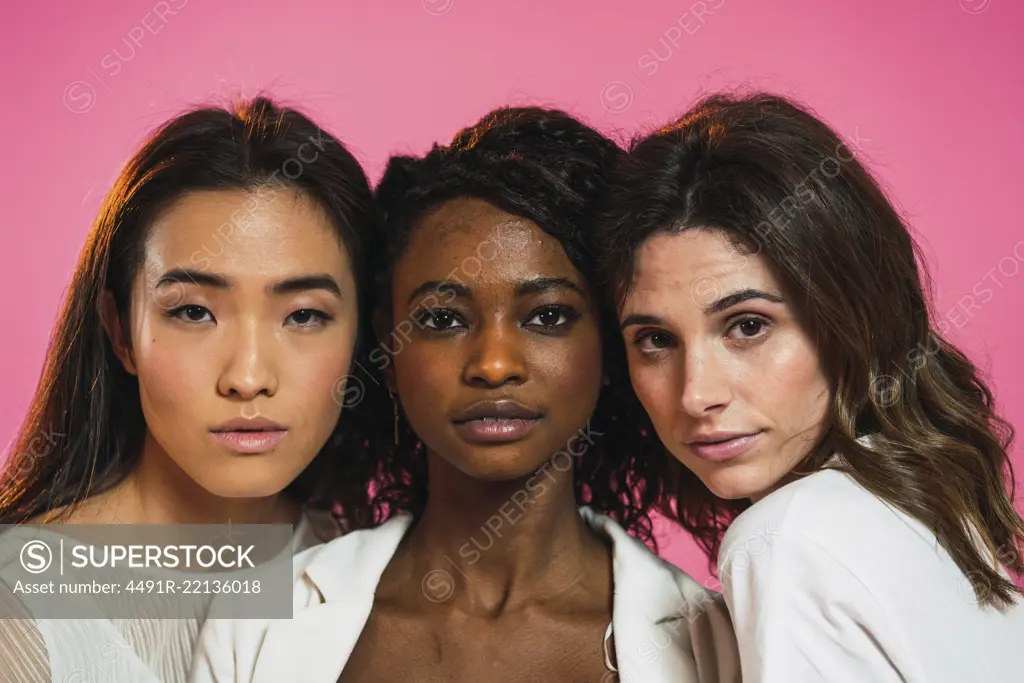 Cheerful multiracial women friends posing