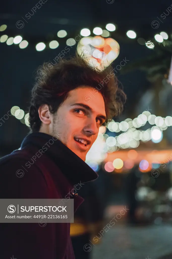 Cheerful man on street at night