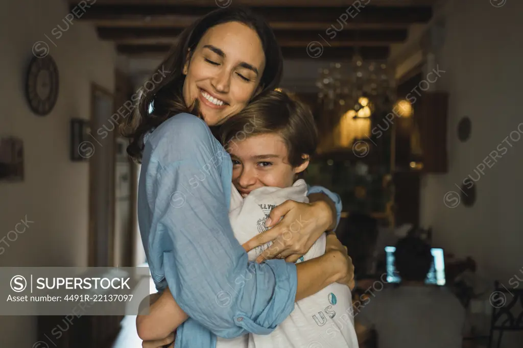 Cheerful mother hugging her son