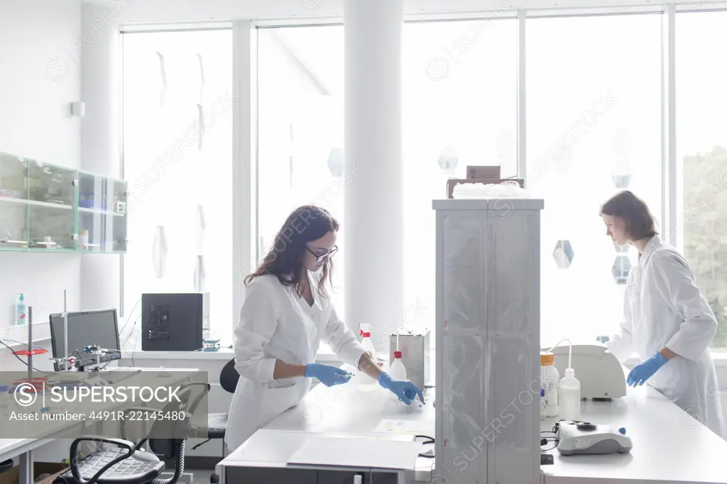 Women standing and working in lab