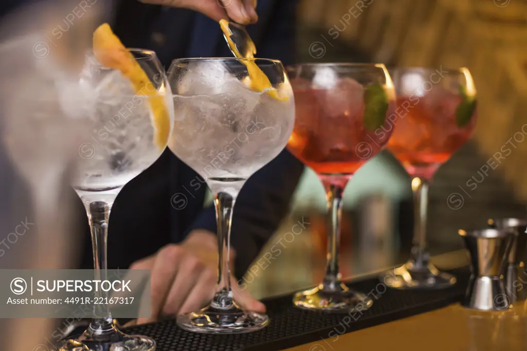 Barman preparing cocktails in pub