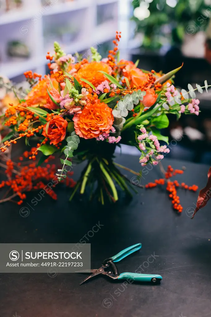 Floral bouquet on the counter in flower shop. Small business, professional occupation, florist.