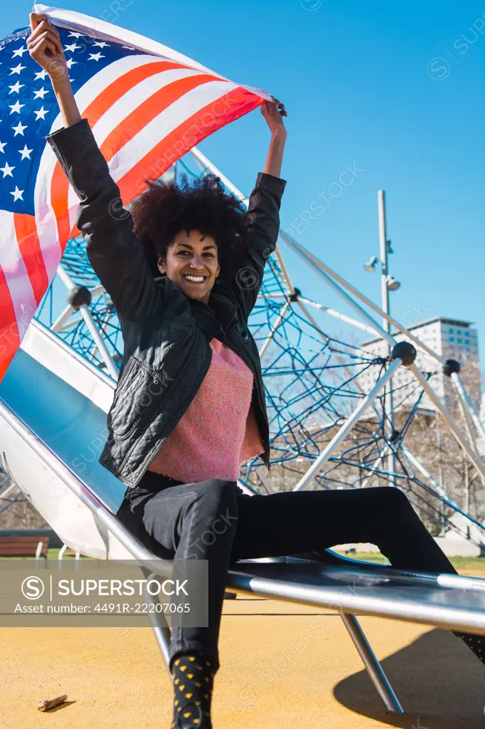 black woman with afro hair and an american flag celebrating the independence day of USA