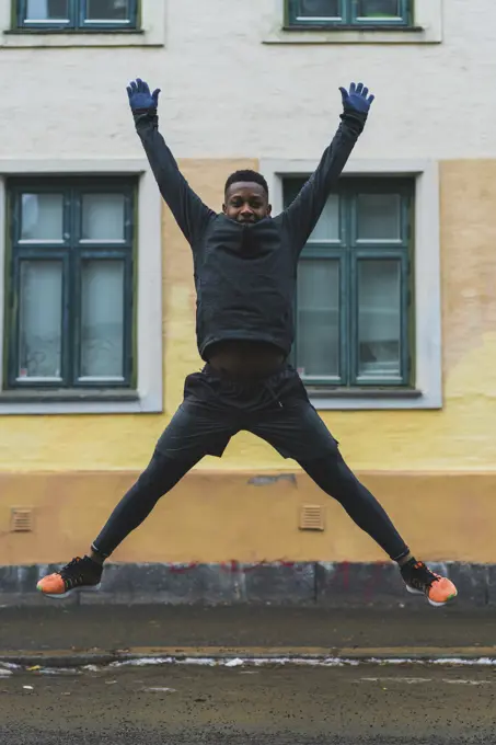 Sportive man jumping on street