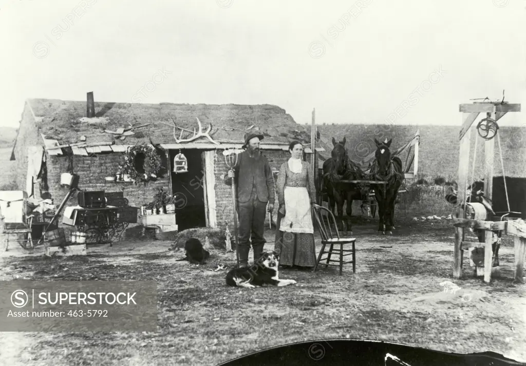 Couple standing in front of a house, John Curry House, Custer County, Nebraska, USA, Photo by Solomon D. Butcher, 1886