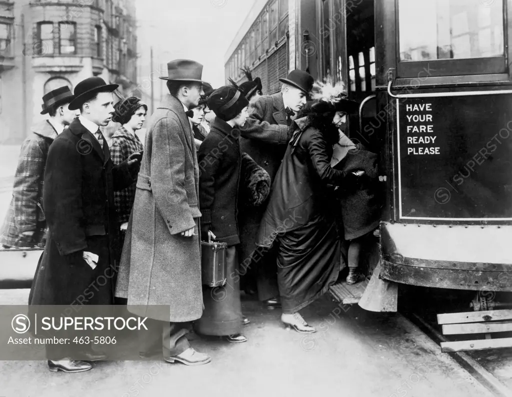 Side profile of a group of people boarding a streetcar, Chicago, Illinois, USA, 1913