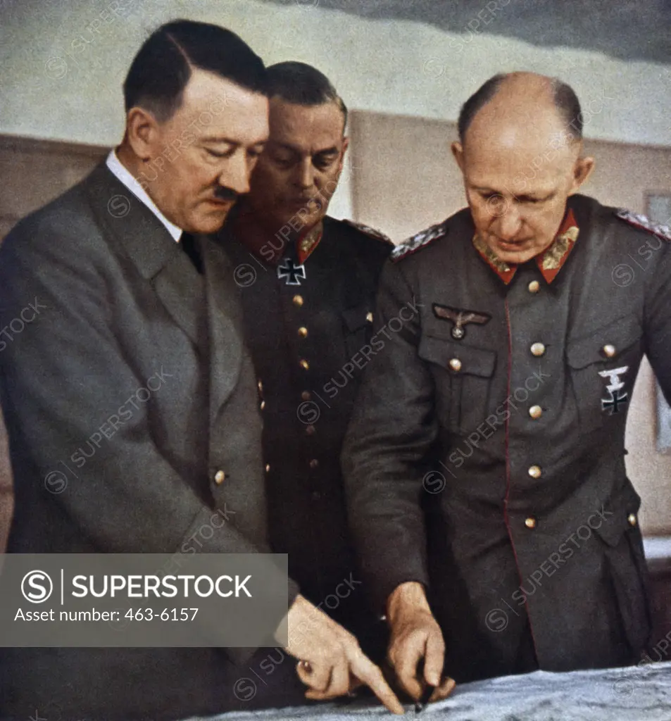 Adolf Hitler, Wilhelm Keitel and Alfred Jodl discuss strategy over a map at Hitler's Headquarters, Germany, c.1941
