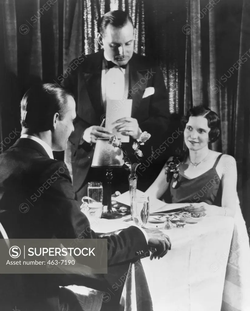 Waiter taking order from a young couple, 1933