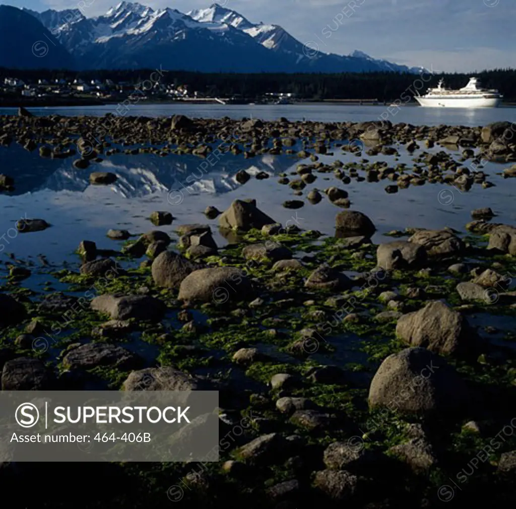 Mossy stones with a cruise ship in a canal, Lynn Canal, Alaska, USA