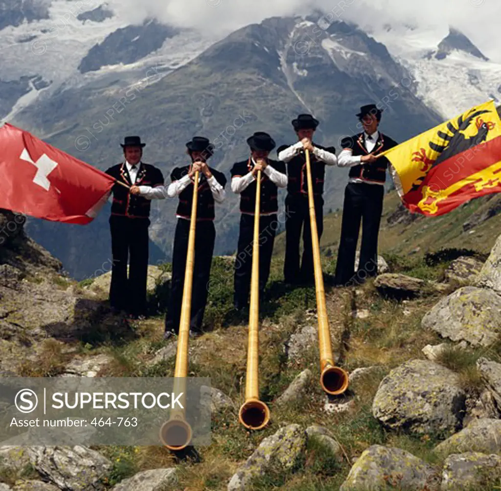 Switzerland,  Valais,  Taschalap,  Men playing on alphorns