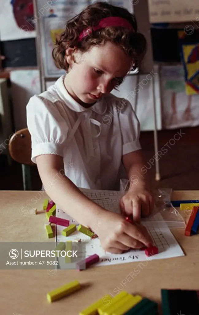Close-up of a girl coloring on a sheet of paper