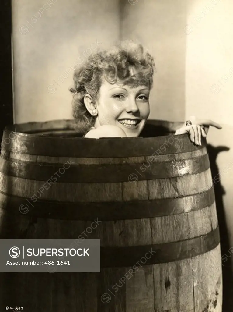 Portrait of smiling woman sitting in barrel