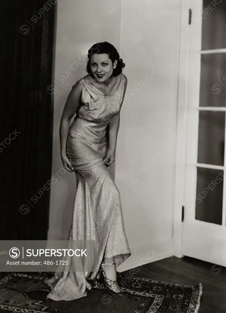 Young woman posing in elegant dress, 1931