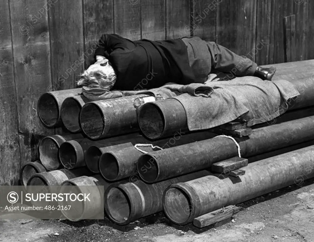 USA, New York City, Bowery, Drunk Man Sleeps In Alley Of Skid Row