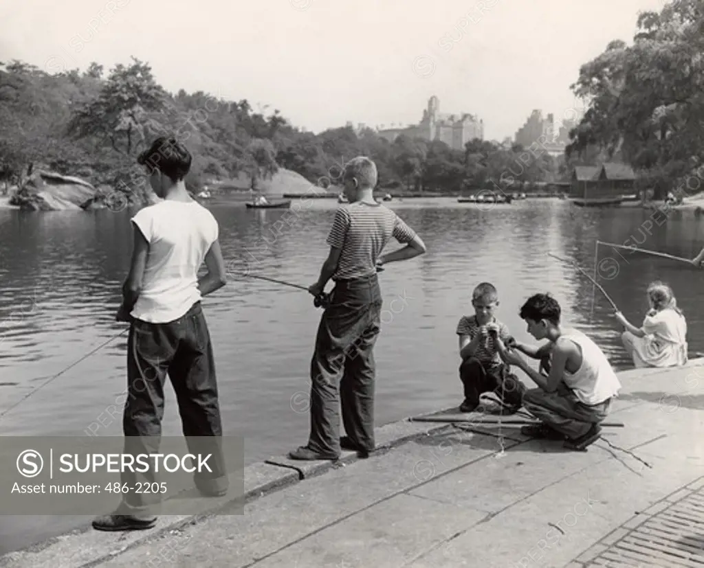 USA, New York City, Central Park, Boys Fishing At Pond