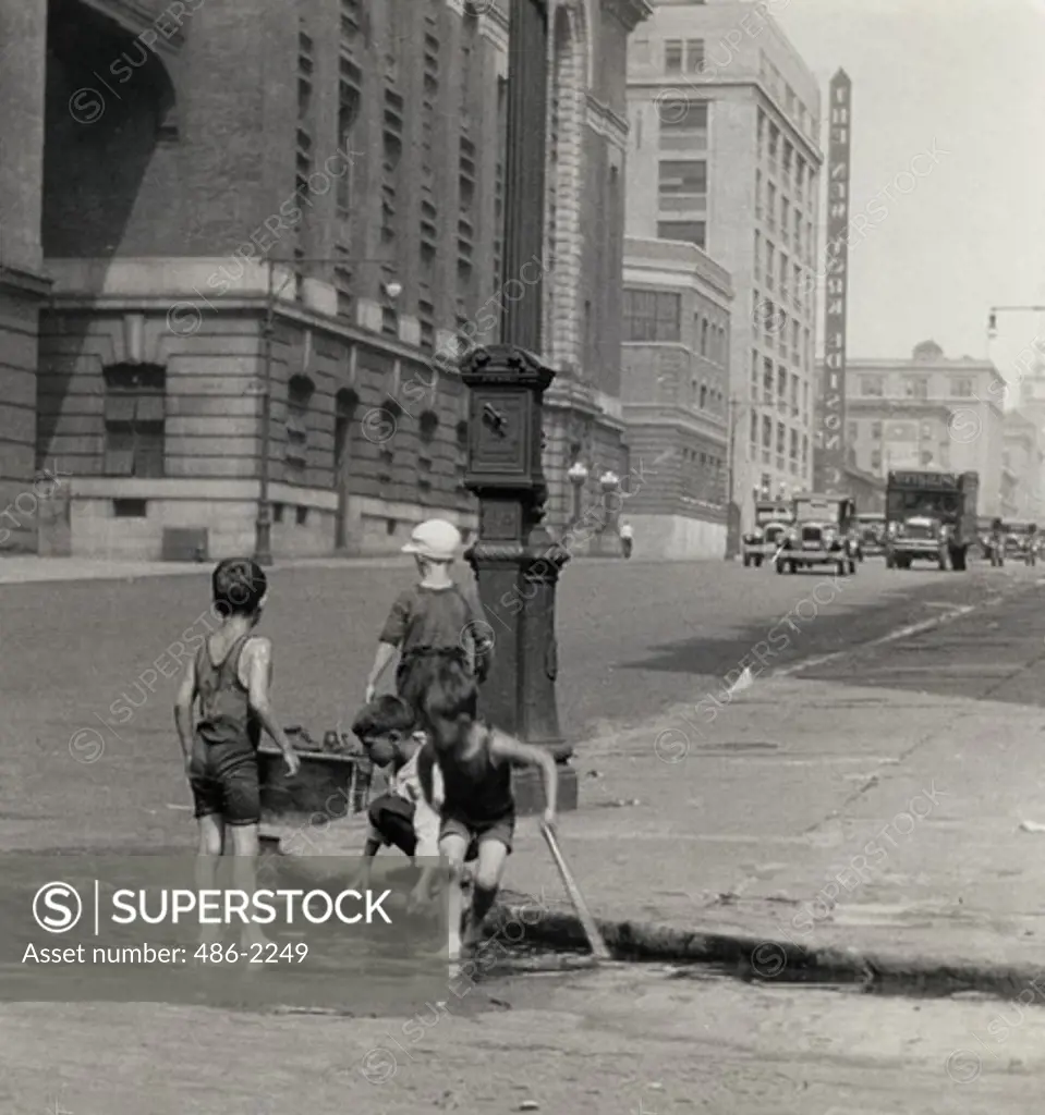 USA, New York City, East Side, Children Playing In Puddle