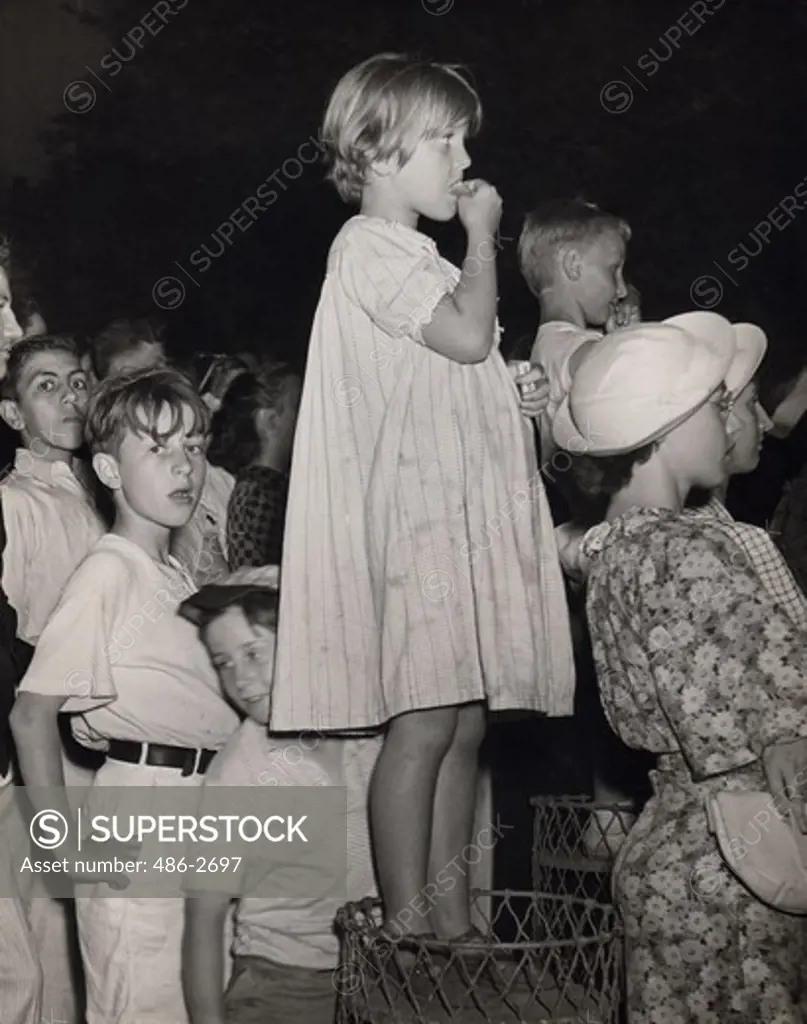 Girl surrounded by crowd watching performance