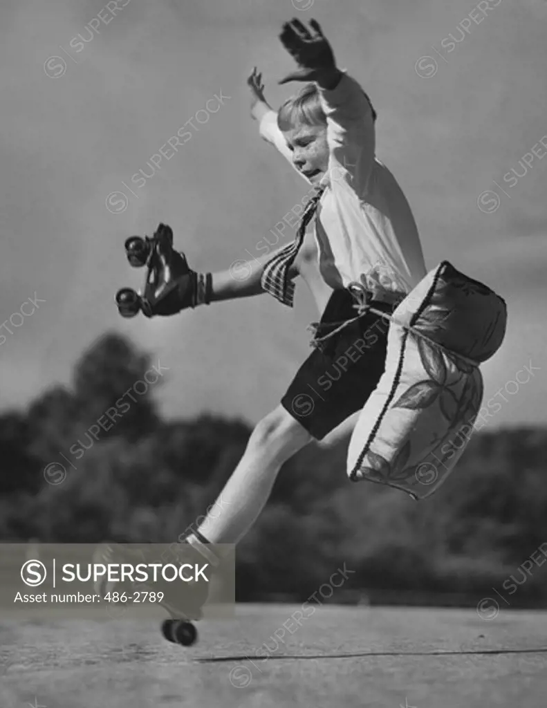 Portrait of boy falling down on roller skates