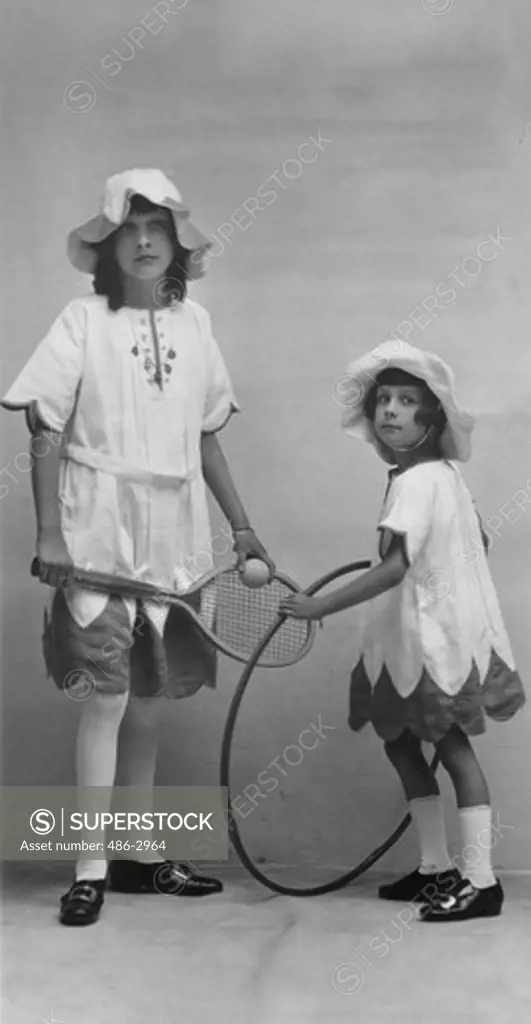 Portrait of two sisters with sports equipment