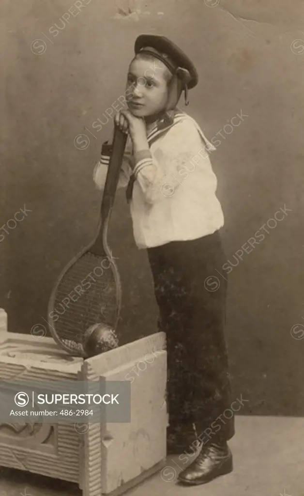 Studio portrait of boy holding badminton racket