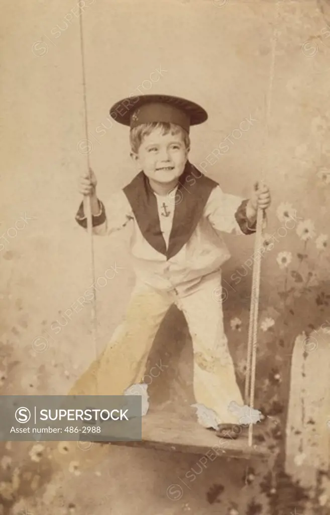 Studio portrait of boy on rope swing