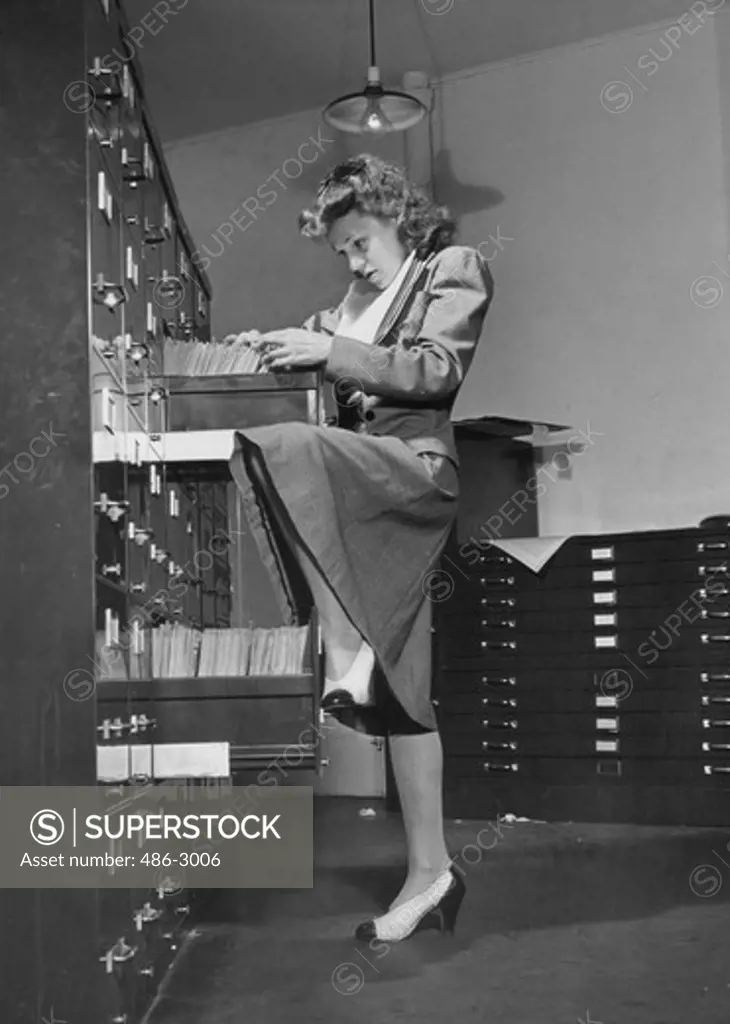 File clerk searching through files