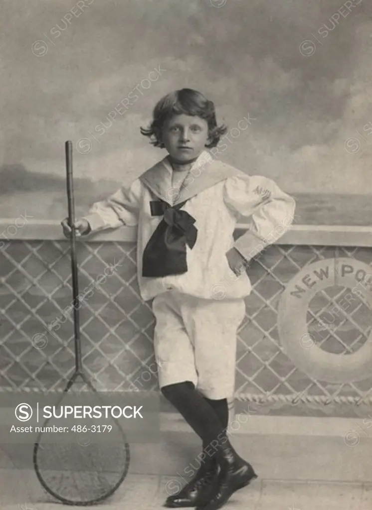 Portrait of boy posing with fishing net, 1896