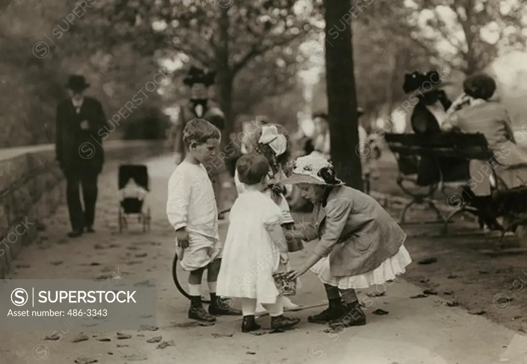 Children playing in park, 1906