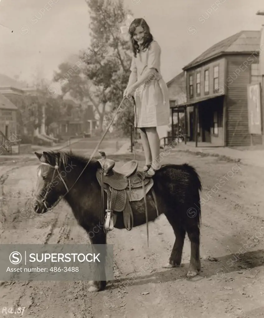 Speaking of Trick Riding. Barbara Kent and 1927 Wampas Star, shows how those circus acrobats get that way. The pony's name is ""general Pico"" and he seems rather bored at such silly going on