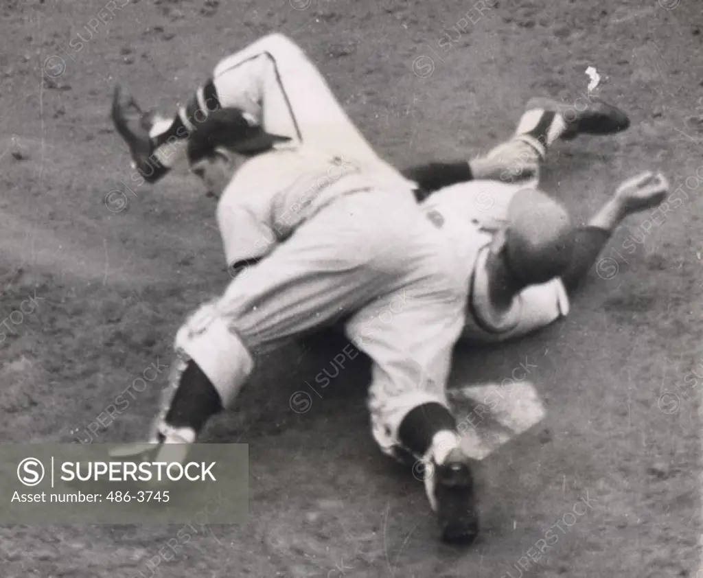 Andy Pafko of Milwaukee Braves Plows into New York Yankees' catcher Yogi Berra as Pafko attempted to score from third on fly ball in second inning of game, Milwaukee, 8 Oct. 1958