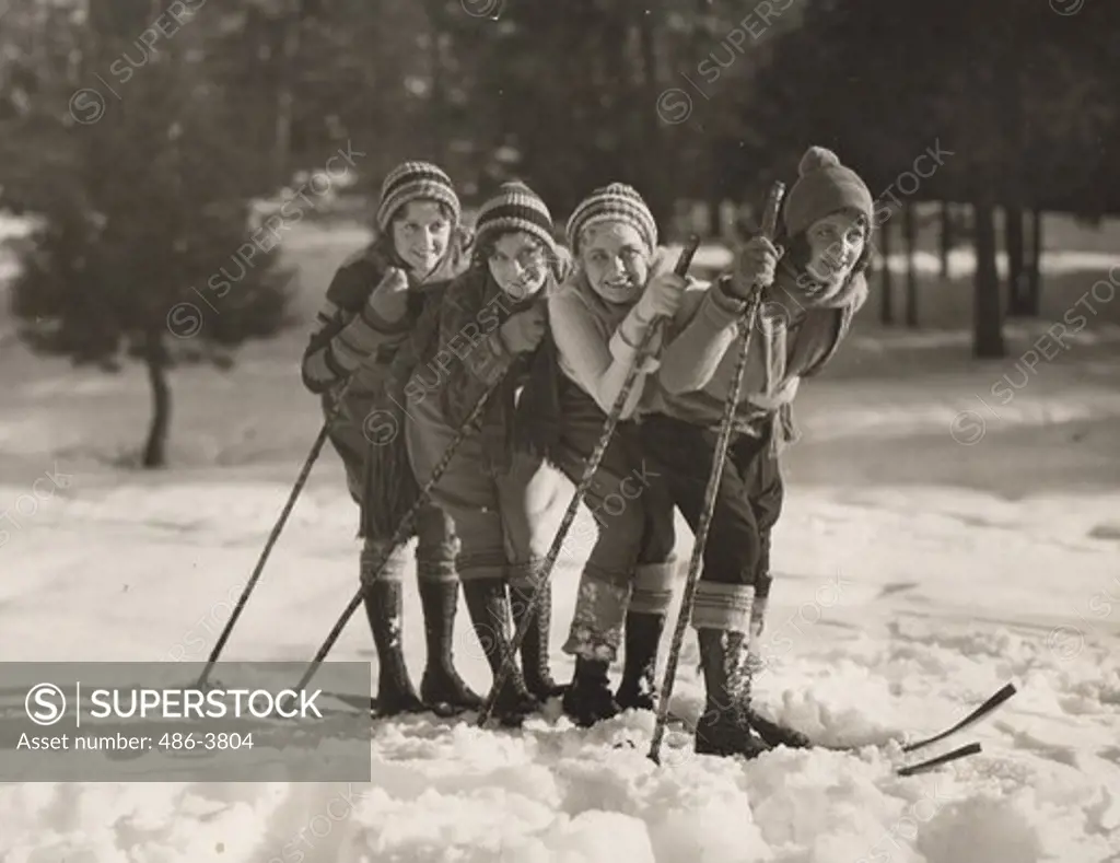 USA, California, Merna Kennedy, followed by John Marsh, Helen Wright and June Marlowe indulging in winter sports in hills of Los Angeles County park after heavy snowfall