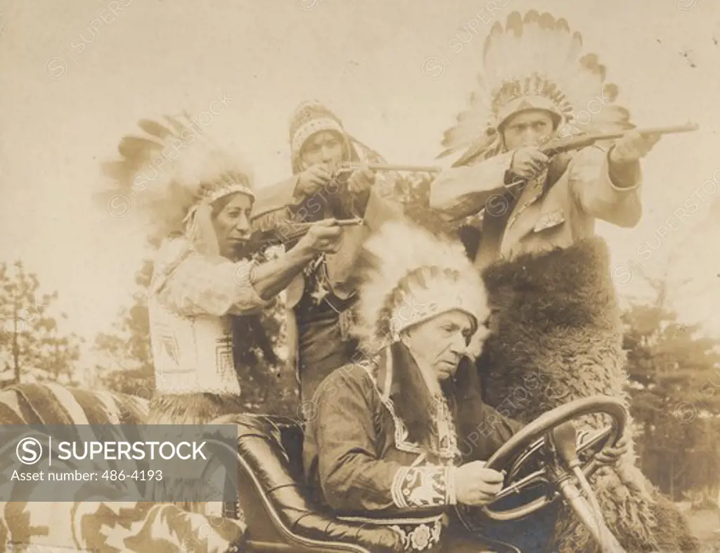 American Indians in car aiming gun
