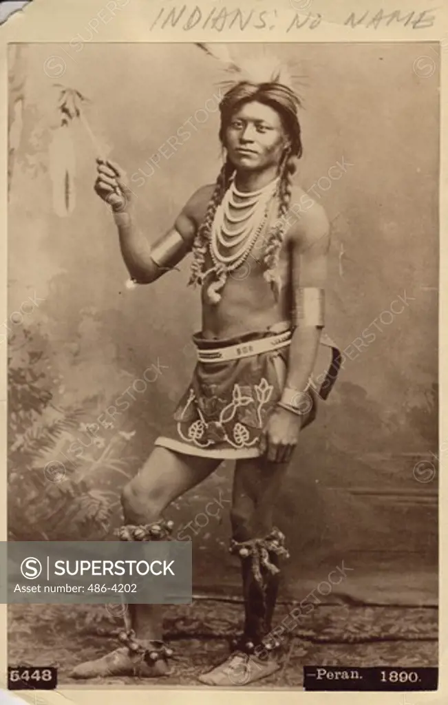 Portrait of American Indian young man holding feather