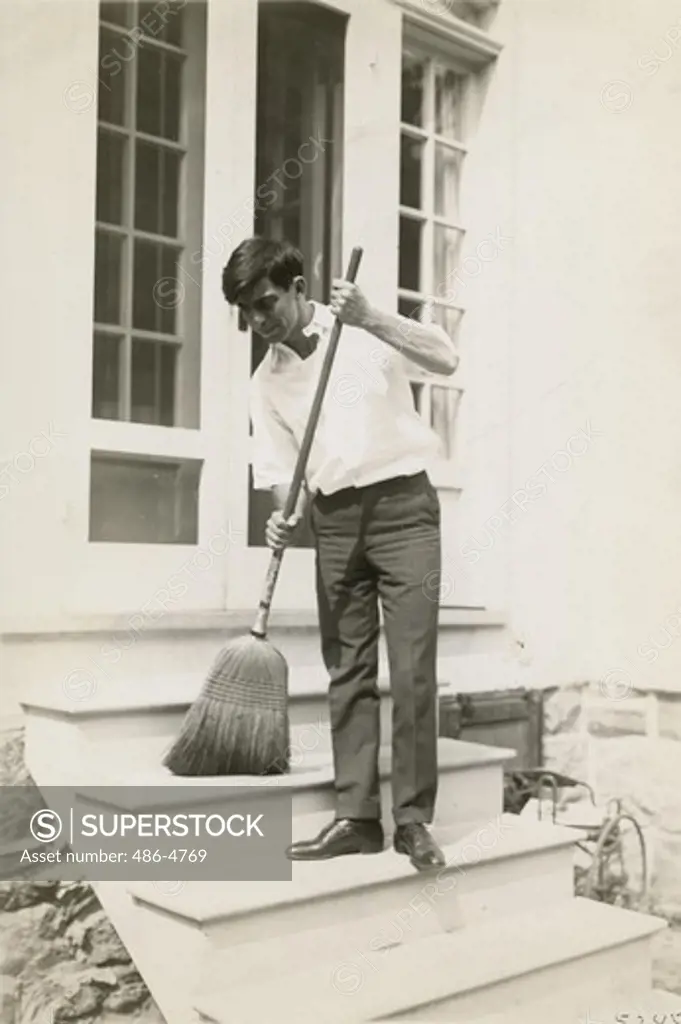 Eddie Cantor sweeping stairs