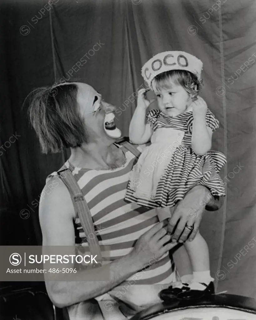 Portrait of Coco Clown with his daughter, Coco the Clown takes time out from his hippodrome hi-jinks to entertain his four year old daughter. The 1965 edition of Ringling Bros. And Barnum & Bailey Circus is the biggest and best of its long history, headlining over 30 brand new European acts and over 100 sensational American Big Top performers.